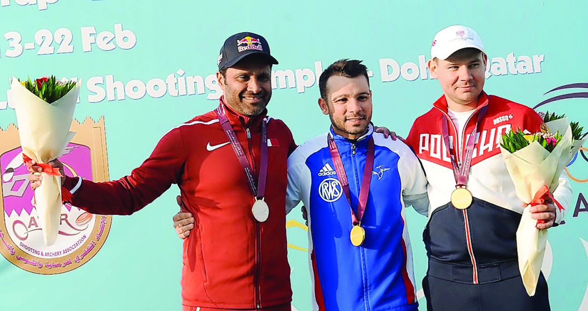 France’s Anthony Terras, winner of the skeet event at the Qatar Open Shotgun championship, celebrates on the podium along with silver medal winner Qatar’s Nasser Saleh bin Al Attiyah (left) and third place winner Anton Astakhov of Russia.