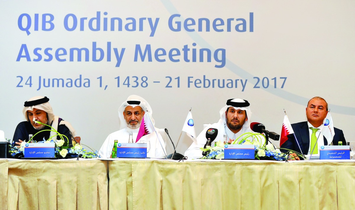 Sheikh Jassim bin Hamad bin Jassim bin Jaber Al Thani (second right), Chairman of QIB, and Abdullatif bin Abdullah Al Mahmoud (second left), Vice-Chairman of QIB with other board members at the Bank's Ordinary General Assembly meeting held at the Four Sea