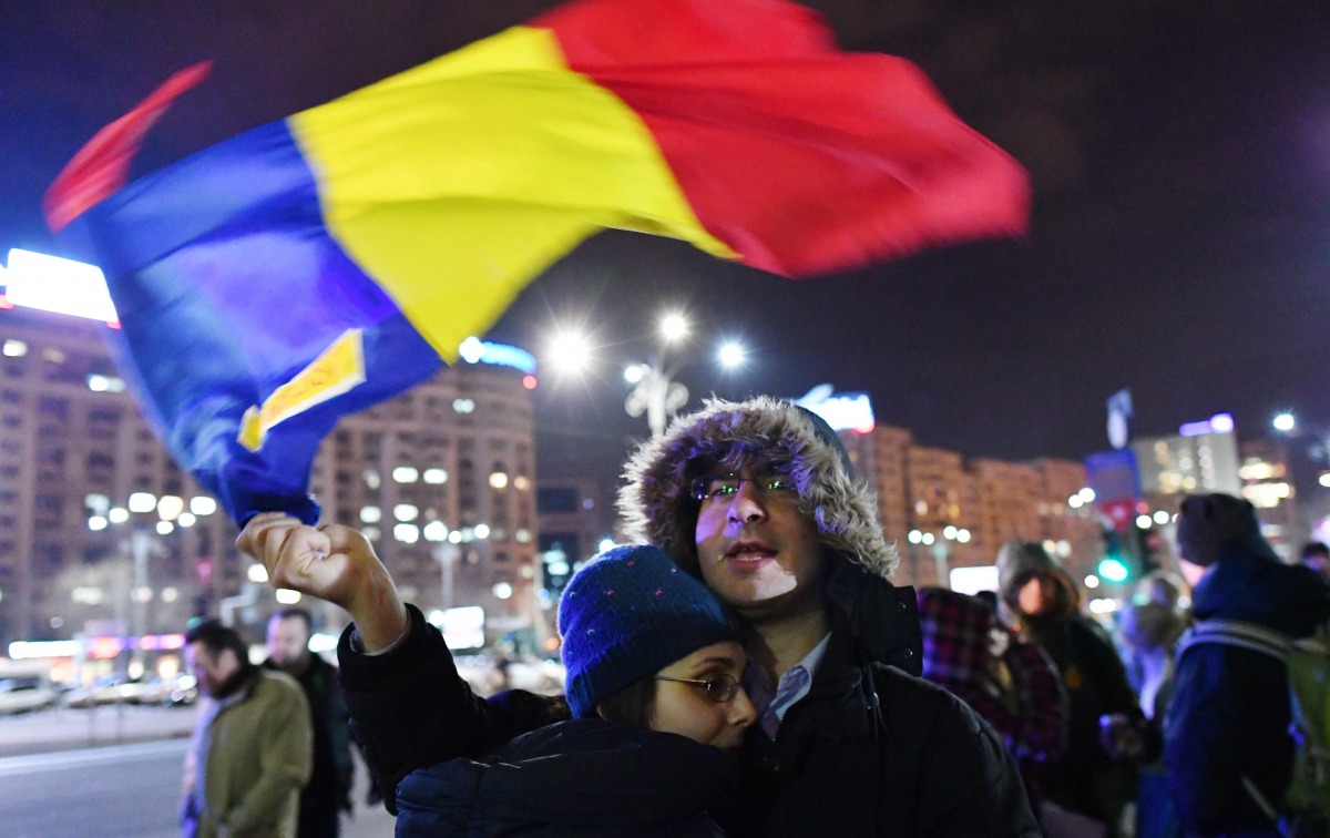 Romanians protest in front of the Romanian Government headquarters in Bucharest on February 21, 2017. Romanian MPs voted to definitively shelve a controversial decree that had sought to water down anti-corruption legislation but ended up unleashing the na