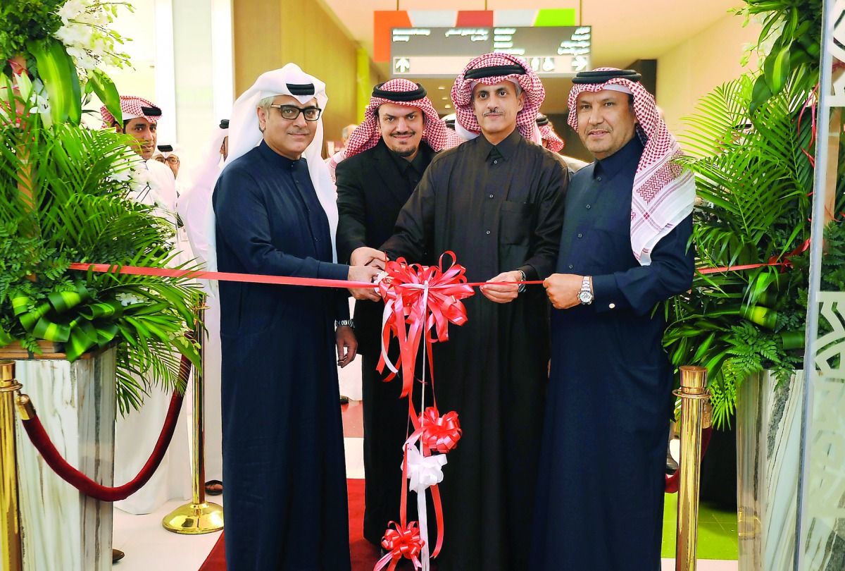 Sheikh Dr Khalid bin Thani bin Abdullah Al Thani (second right), Chairman and Managing Director of Qatar International Islamic Bank (QIIB), cutting a ribbon with other officials and guests during the opening of bank's new branch at the Mall of Qatar yeste