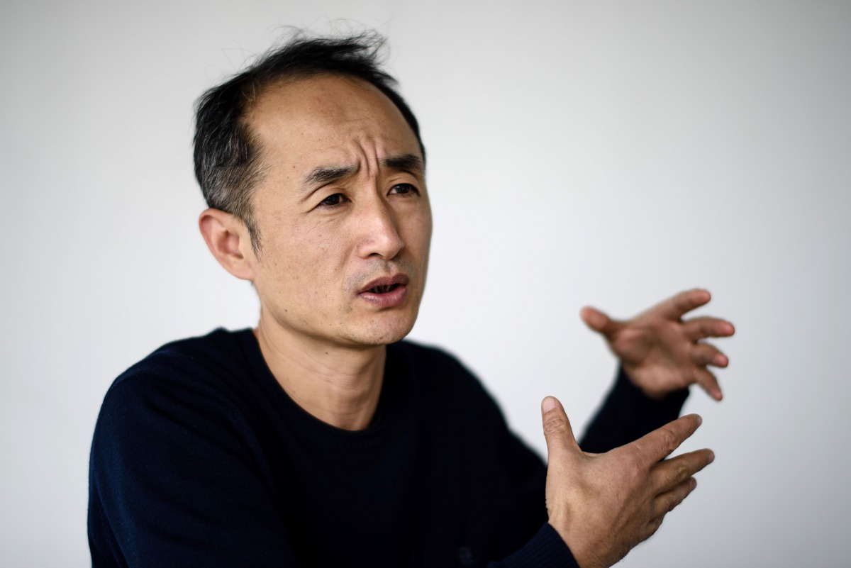 In this picture taken on February 8, 2017, Chinese film-maker Wen Hai, 46, gestures during an interview on his documentary 
