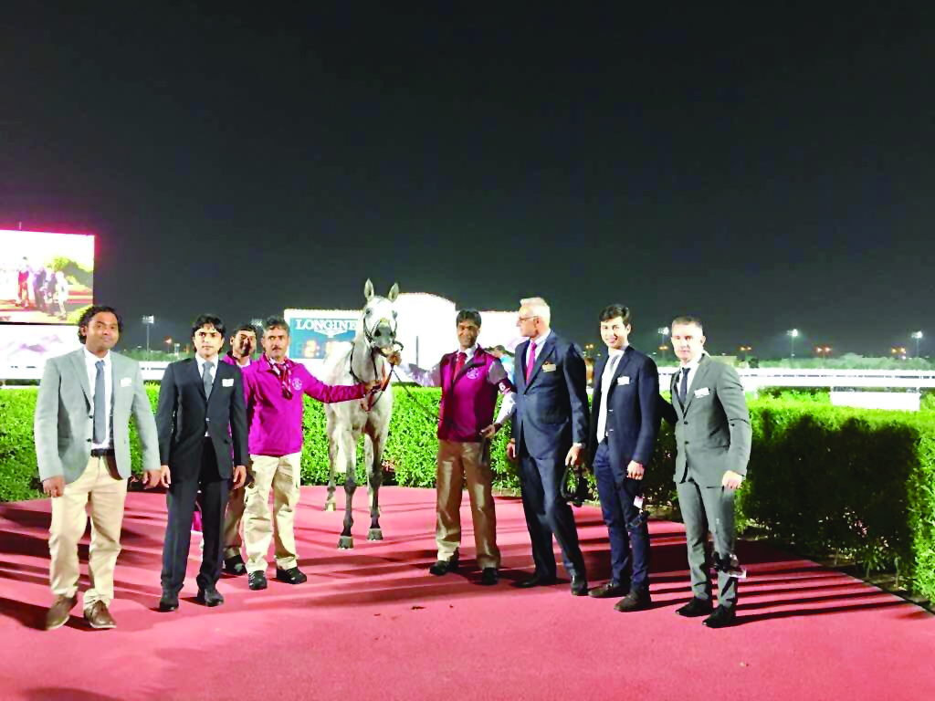 Victorious horse Majeed's owner and Qatar Racing and Equestrian Club officials pose for a photograph during the H H the Emir’s Sword Racing Festival at Al Rayyan Racecourse yesterday.