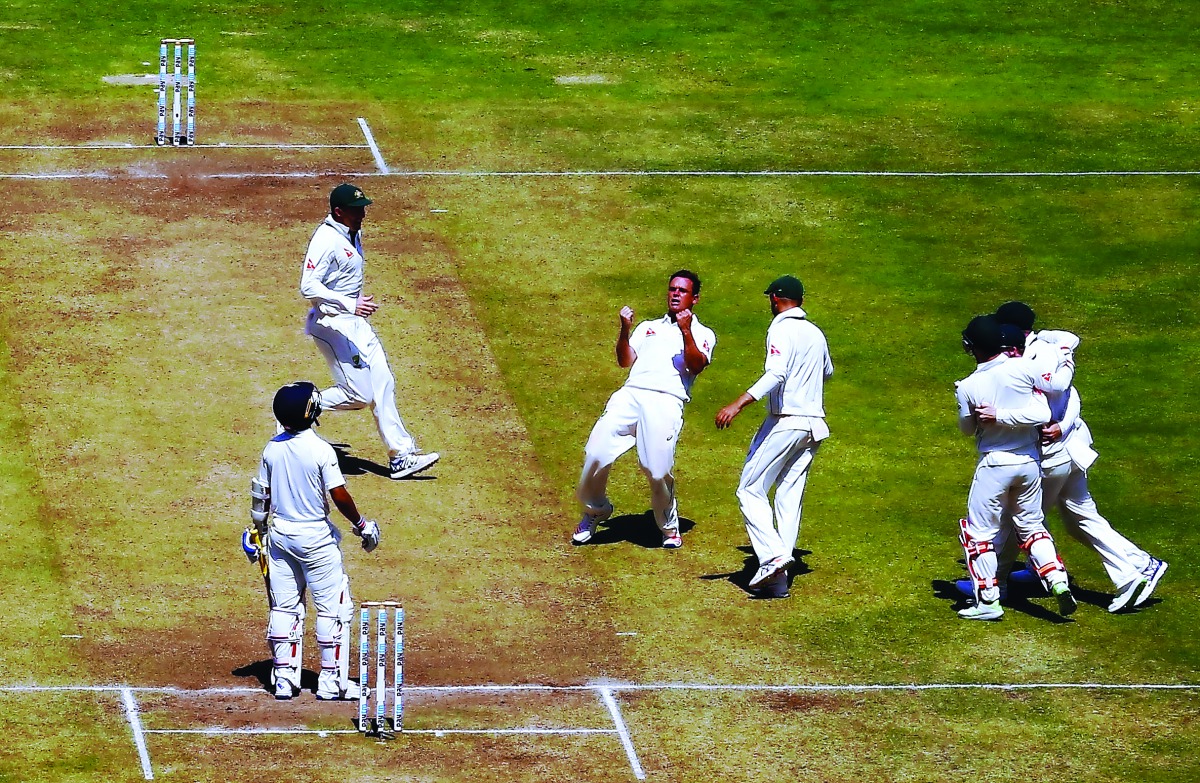 . Australia's Steve O'Keefe (centre) celebrates after taking the wicket of India's Ajinkya Rahane (left) during the second day of their first Test played at Maharashtra Cricket Association Stadium in Pune, India yesterday.