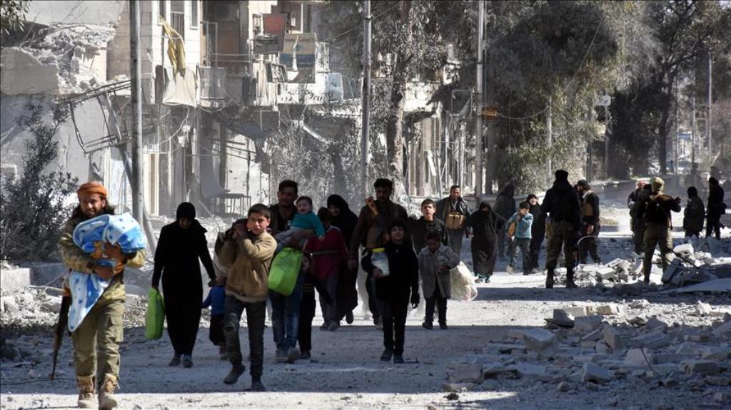 Members of Free Syrian Army (FSA) escort civilians after their victory in the Syrian town of Al Bab after the town center has been entirely freed from Daesh terrorists as part of the 