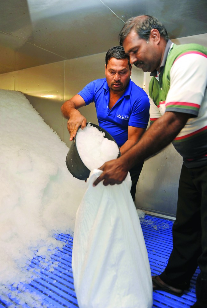 A customer buying crushed ice at the Ice Factory. Pic: Abdul Basit / The Peninsula