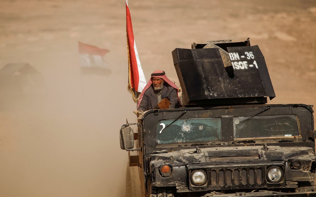 A displaced elderly Iraqi man who just fled his home arrives on military humvee at Sepcial forces base , as Iraqi forces battle with Islamic State militants, in western Mosul, Iraq February 27, 2017. REUTERS/Zohra Bensemra
