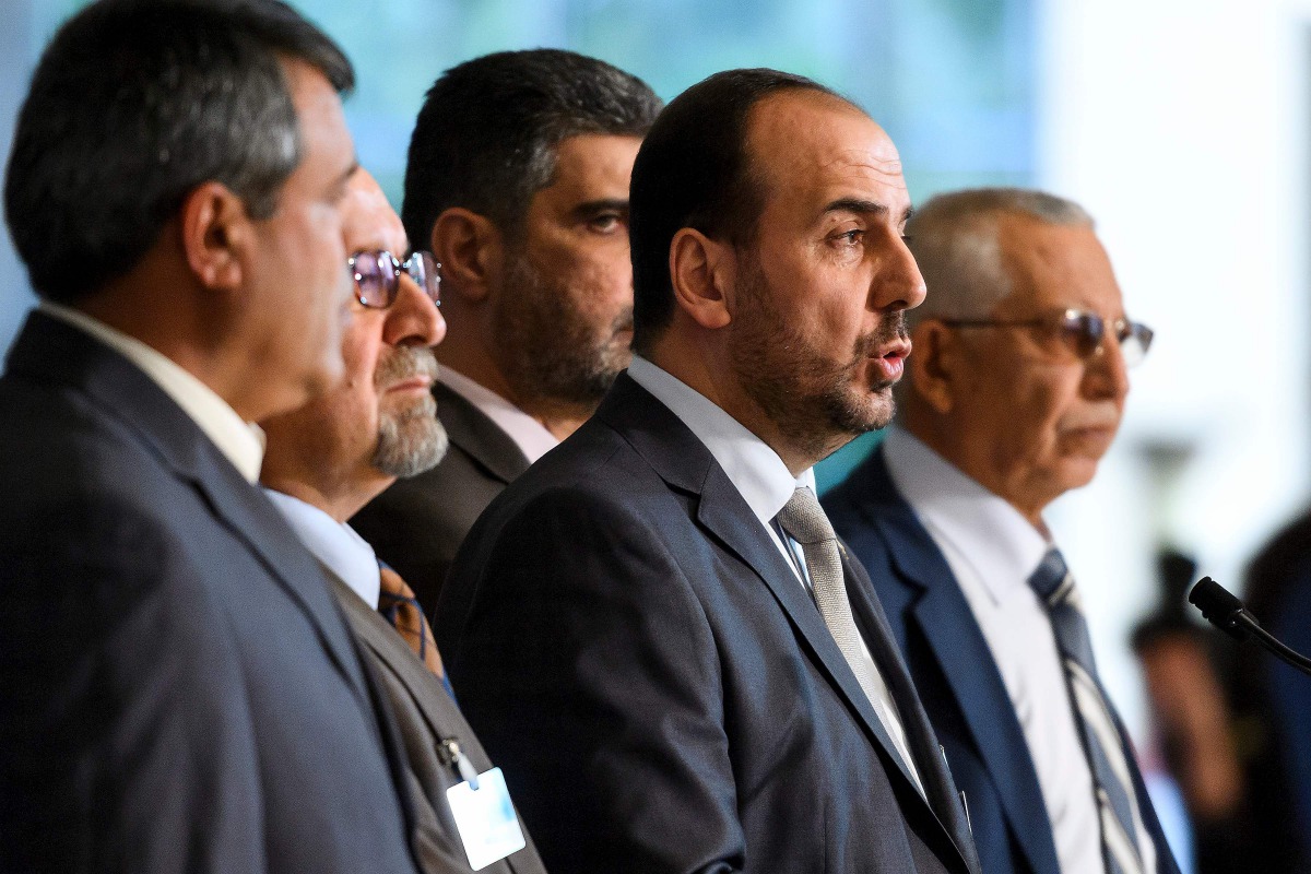 Syria's main opposition High Negotiations Committee (HNC) leader Nasr al-Hariri (2nd R) speaks to reporters after a meeting with UN Special Envoy during Syria peace talks on February 27, 2017 in Geneva. A ban on mobile phones, recording devices and 