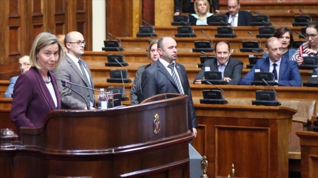 High Representative of the European Union for Foreign Affairs and Security Policy, Federica Mogherini (R) addresses the Serbian deputies at the Serbian National Assembly as opposition SRS party and Dveri Movement members of the assembly protest her in Bel