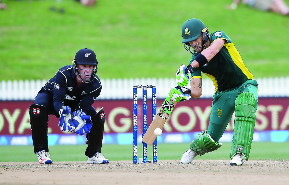 Faf du Plessis (right) of South Africa bats watched by Luke Ronchi of New Zealand during their fourth ODI at Seddon Park in Hamilton on March 1.