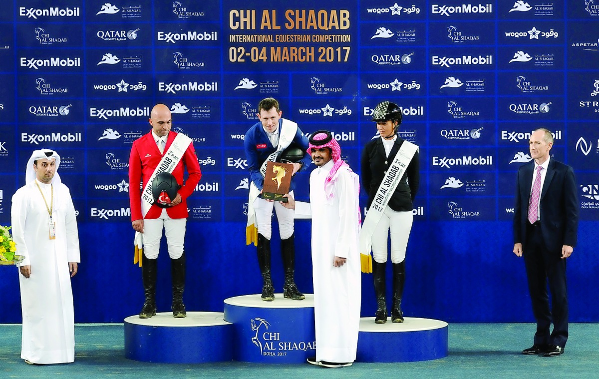 H E Sheikh Joaan bin Hamad bin Khalifa Al Thani, President of Qatar Olympic Committee, presenting the trophy to Scott Brash of Great Britain, winner of the CSI5* event at the CHI Al Shaqab, at Al Shaqab Arena yesterday. Omar Karaevli of Turkey finished se