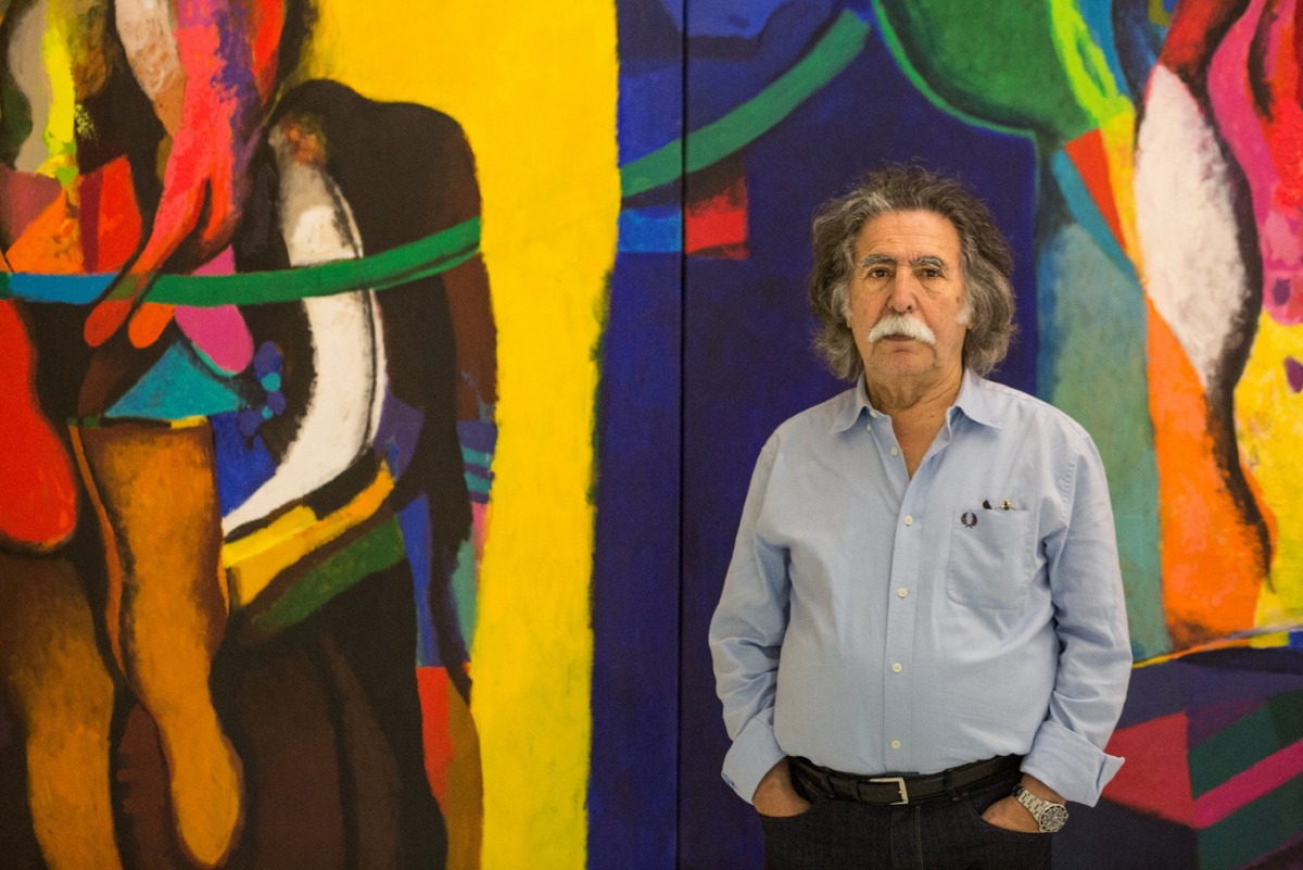 Iraqi artist Dia Al-Azzawi poses for a picture with his work at the Arab Museum of Modern Art in the Qatari capital Doha on October 19, 2016  (AFP Photo / Olya Morvan) 