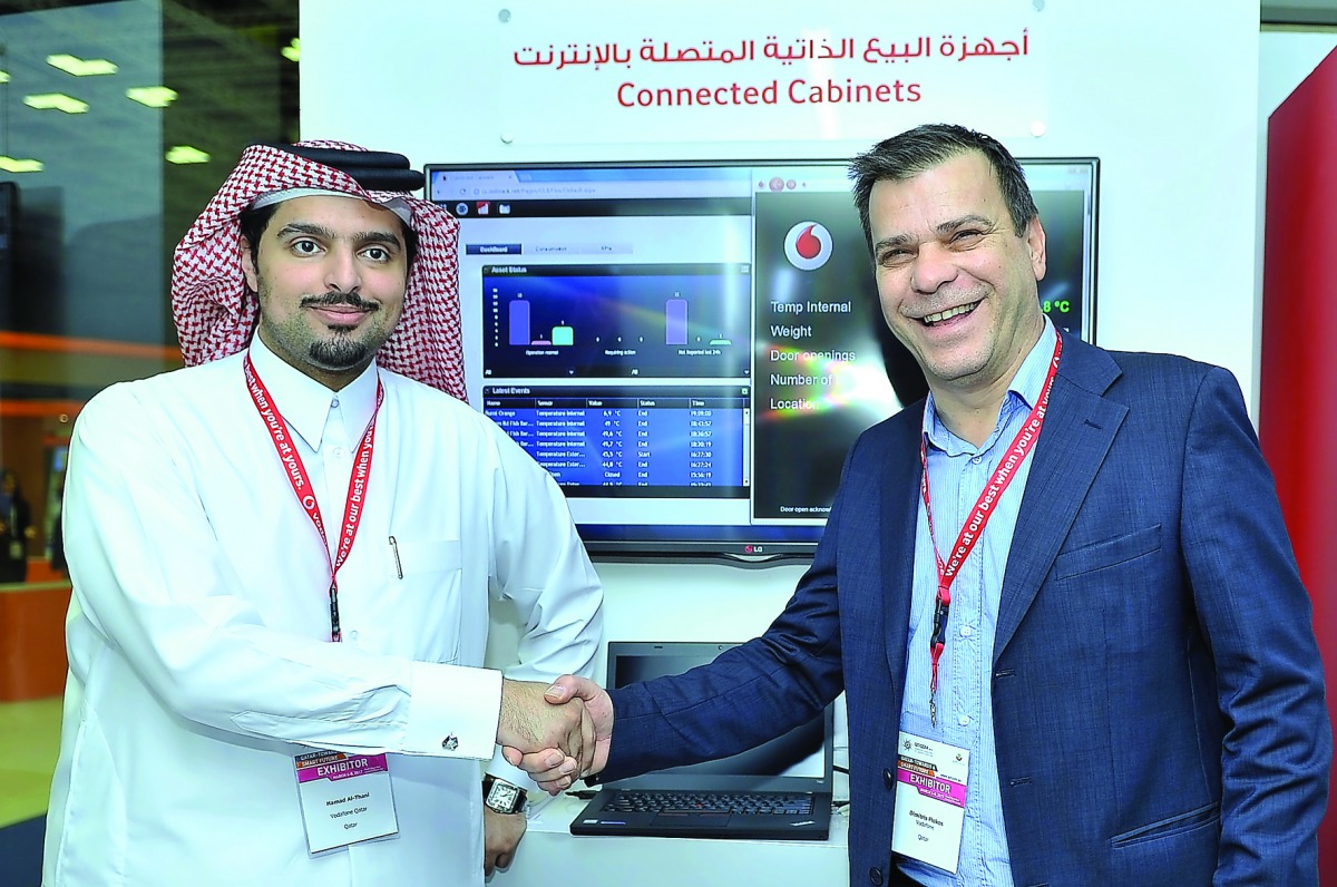 Sheikh Hamad bin Abdullah Al Thani (left), Director of Enterprise Sales, Vodafone Qatar, with Dimitris Flokos, Zelitron’s Business Development Director at the Vodafone booth at QITCOM Conference and Exhibition, yesterday.  Pic: Baher Amin / The Peninsula