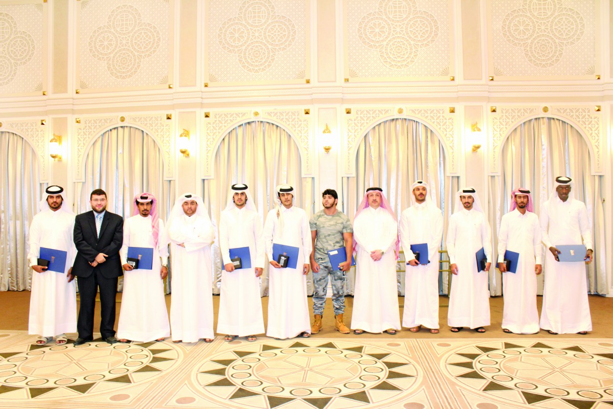 Students and officials of Qatar Chemical Company Ltd, at the graduation ceremony.