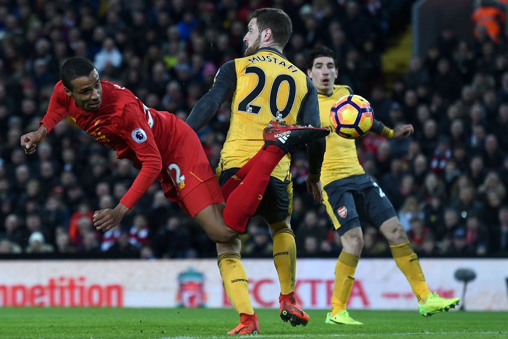 Liverpool's German-born Cameroonian defender Joel Matip (L) tries to reach the ball during the English Premier League football match between Liverpool and Arsenal at Anfield in Liverpool, north west England on March 4, 2017. AFP / Paul ELLIS 
