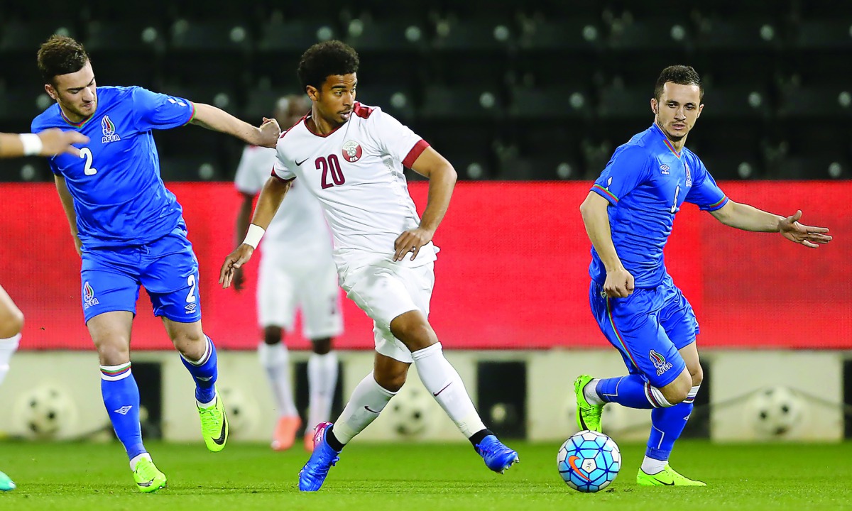 Qatar's  Akram Afif  (centre) vies for the ball possession with two Azerbaijani players during the friendly. Azerbaijan won 2-1 yesterday.
