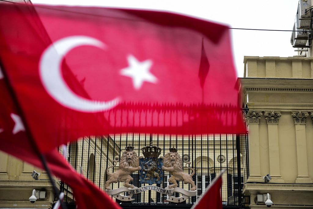 This picture taken on March 12, 2017, shows a Turkish national flag waved in front of the Dutch Consulate in Istanbul. AFP / YASIN AKGUL
