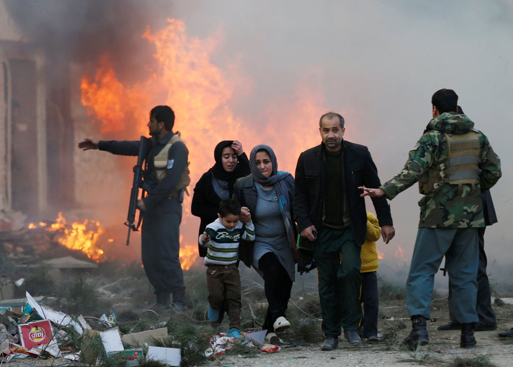 Survivors walk after a blast in Kabul, Afghanistan March 13, 2017. REUTERS/Mohammad Ismail
