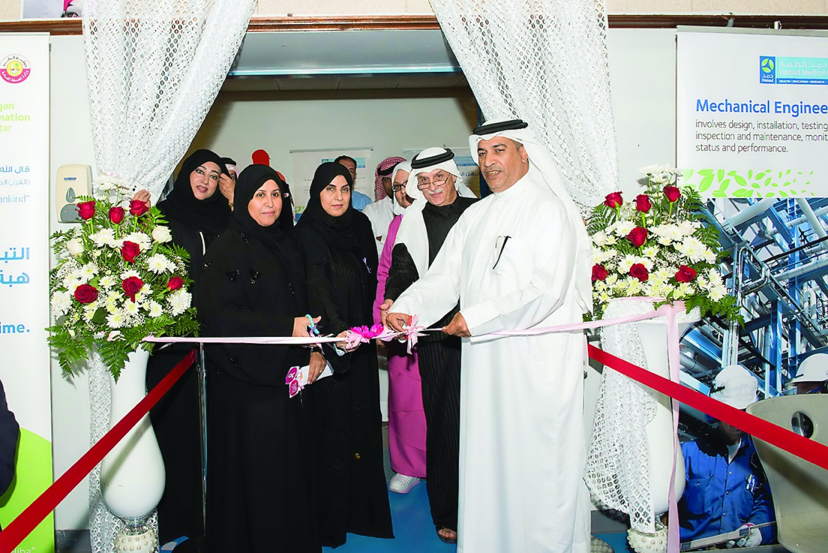 HMC officials cutting the ribbon to open the exhibition.