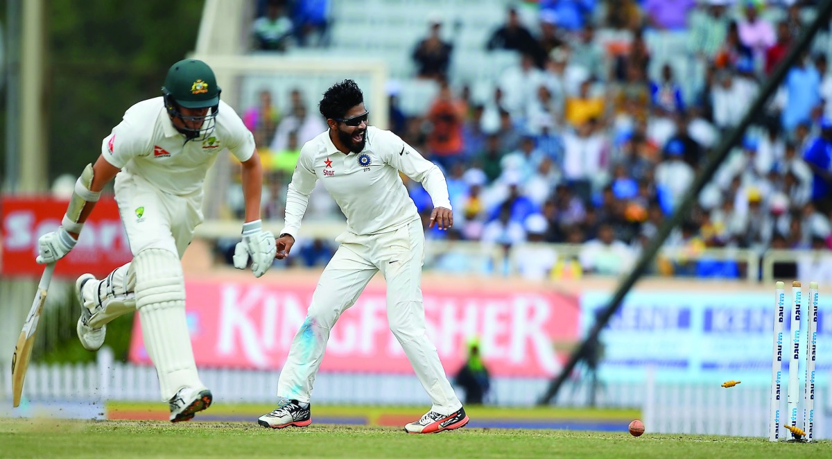 Indian bowler Ravindra Jadeja (right) runs out Australian batsman Josh Hazlewood on the second day of the third Test cricket match at the Jharkhand State Cricket Association (JSCA) Stadium Complex in Ranchi.
