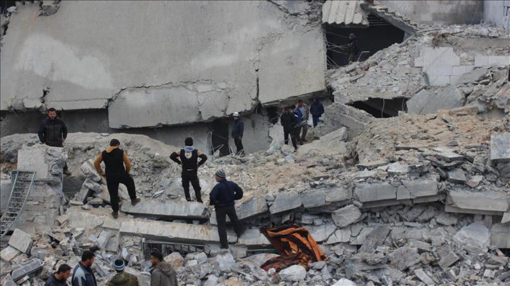 Civil defense units and people try to rescue victims who were trapped under the debris of a mosque after war crafts belonging to USA carried out series of airstrikes during night prayer in Al-Jineh village of Atarib district in Aleppo, Syria on March 17, 
