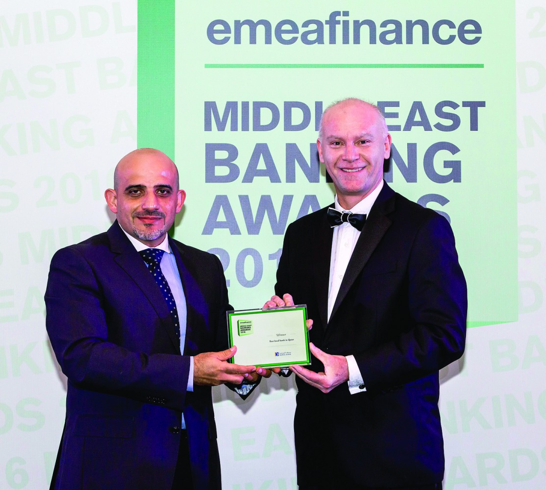 Doha Bank official receiving the award.