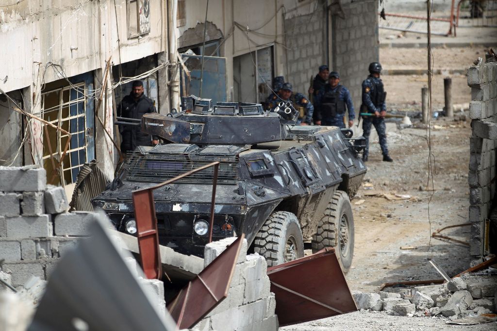 Iraqi forces, consisting of the Iraqi federal police and the elite Rapid Response Division, advance in the Old City in western Mosul on March 19, 2017, during the offensive to retake the city from Islamic State (IS) group fighters. / AFP / AHMAD AL-RUBAYE