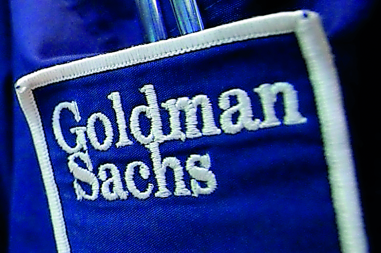 The logo of Goldman Sachs is seen on the clothing of a trader working at the Goldman Sachs stall on the floor of the New York Stock Exchange.