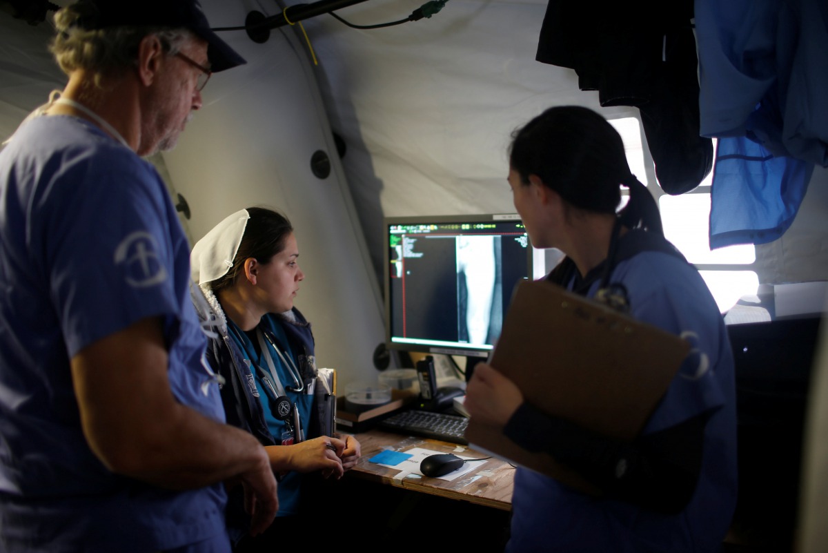 Foreign volunteers work at the emergency field hospital which is run by the US Christian charity Samaritan's Purse, eastern Mosul, Iraq March 22, 2017. REUTERS/Suhaib Salem