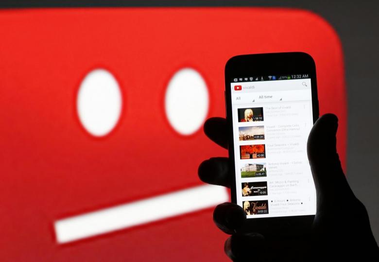 A picture illustration shows YouTube on a cell phone, in front of a YouTube copyright message regarding a video on an LCD screen, in central Bosnian town of Zenica, early June 18, 2014. REUTERS/Dado Ruvic