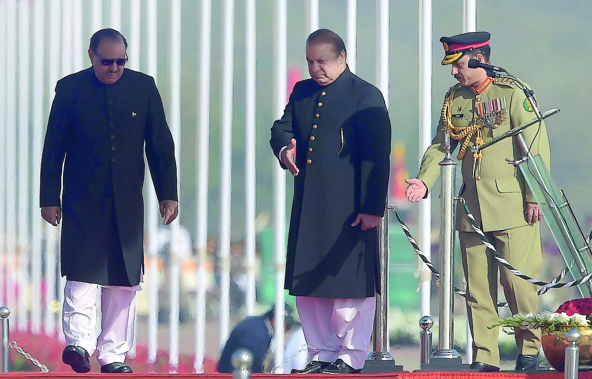 Pakistan's Prime Minister Nawaz Sharif (centre) guides President Mamnoon Hussain during a Pakistan Day military parade, in Islamabad, yesterday. 