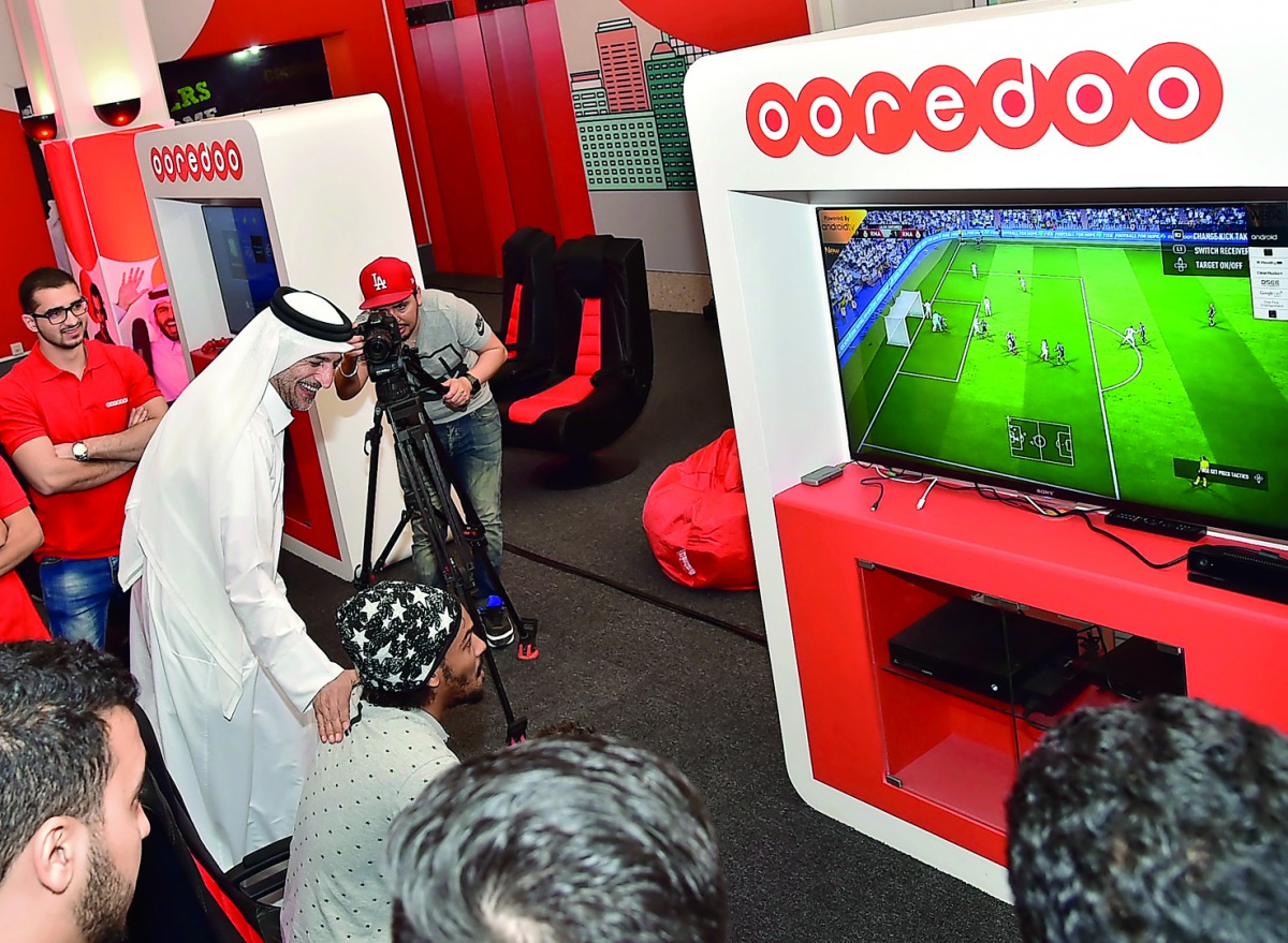 Qatar University students watch a football match on television at the Student Entertaining Majlis.