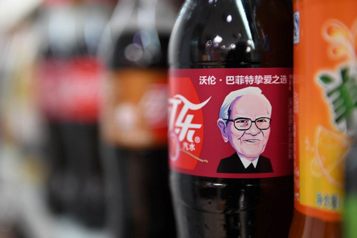 A Cherry Coke bottle featuring an image of US investor Warren Buffet is seen on a shelf at a convenience store in Beijing on April 5, 2017. AFP / Greg Baker
