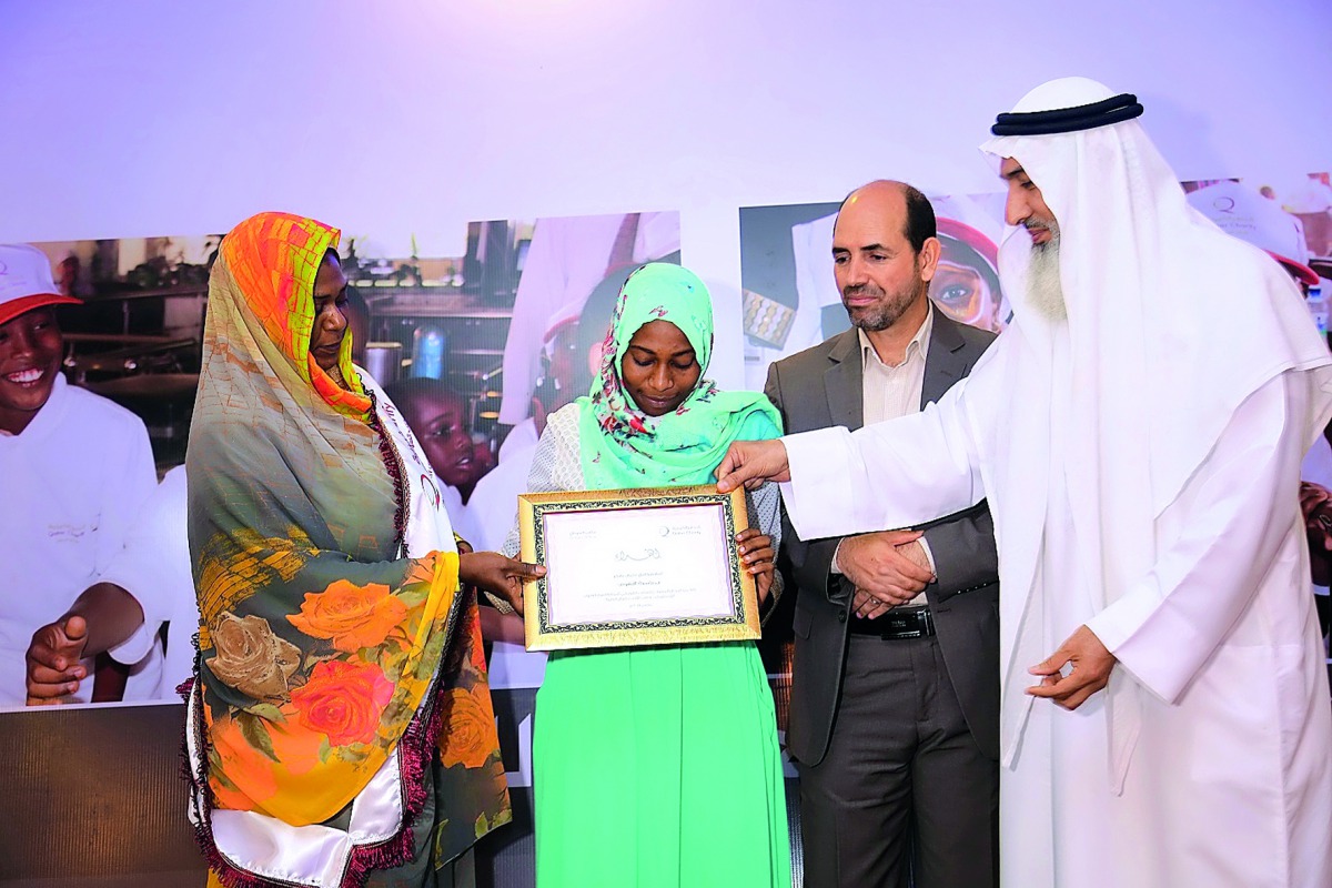 Qatar Charity officials awarding a winner of one of the competitions organised to mark International Day of Orphans.