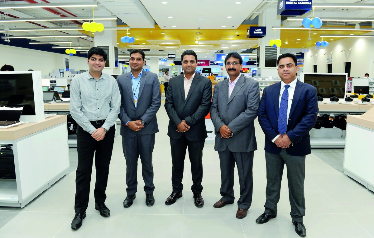 Officials of Sharaf DG, Ganesh Mithra P (second right), Country Head, Qatar and Bahrain; Suresh Babu (right), Store Manager at Ezdan Mall; Mohan Kumar (second left), Store-in-Charge at Doha Festival City (DFC), with other officials after a soft opening of