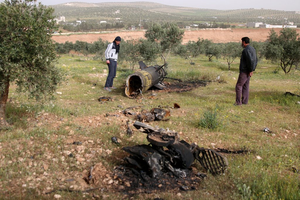 Men inspect a piece of a rocket that landed south of Daraa Al-Balad, Syria, April 5, 2017. REUTERS/Alaa Al-Faqir.