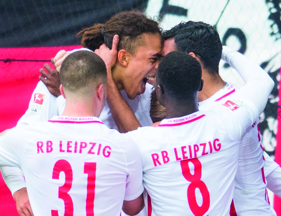Leipzig's Yussuf Poulsen (centre) celebrates after scoring a goal against Leverkusen during their Bundesliga game, yesterday.  