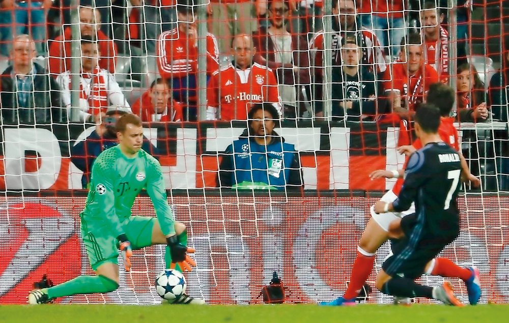 Real Madrid's Portuguese forward Cristiano Ronaldo (right) scores their second goal past Bayern Munich's goalkeeper Manuel Neuer during their UEFA Champions League 1st leg quarter-final football match in Munich, southern Germany yesterday.