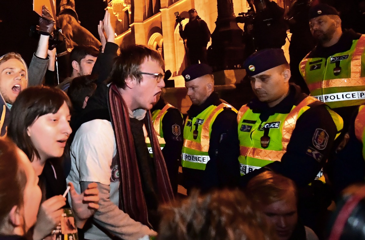 Young students shout an anti-government slogan in front of a police-line during a demonstration against Hungarian Prime Minister Viktor Orban's government in front of the parliament building on April 12, 2017 in Budapest. Thousands of Hungarians joined fr