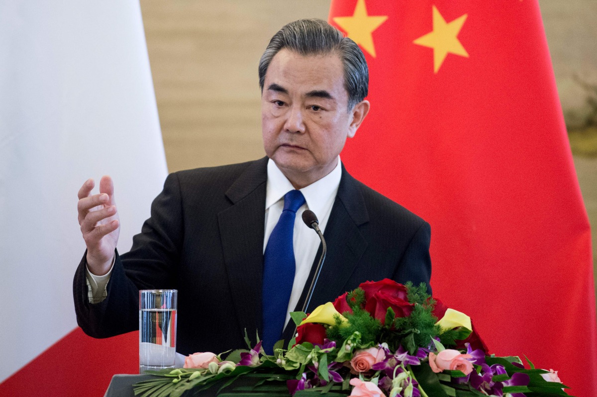 China's Foreign Minister Wang Yi speaks to journalists with his French counterpart Jean-Marc Ayrault during a press conference after their meeting in Beijing on April 14, 2017. China's foreign minister Wang Yi said during a press conference on April 14 th