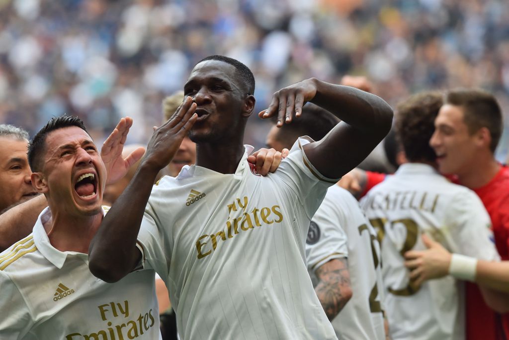 AC Milan's defender from Colombia Cristian Zapata celebrates with teammates after scoring a goal during the Italian Serie A football match Inter Milan vs AC Milan at 