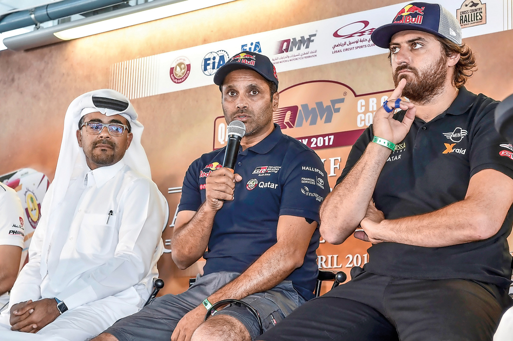 Toyota Hilux Overdrive racing's Qatari driver Nasser Saleh Al Attiyah (centre) speaks during a pre-event press conference yesterday.