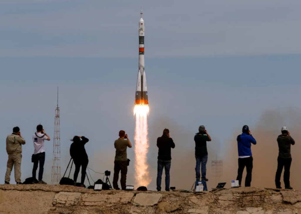 Photographers take pictures as the Soyuz MS-04 spacecraft carrying the crew of Jack Fischer of the U.S. and Fyodor Yurchikhin of Russia blasts off to the International Space Station (ISS) from the launchpad at the Baikonur Cosmodrome, Kazakhstan, April 20