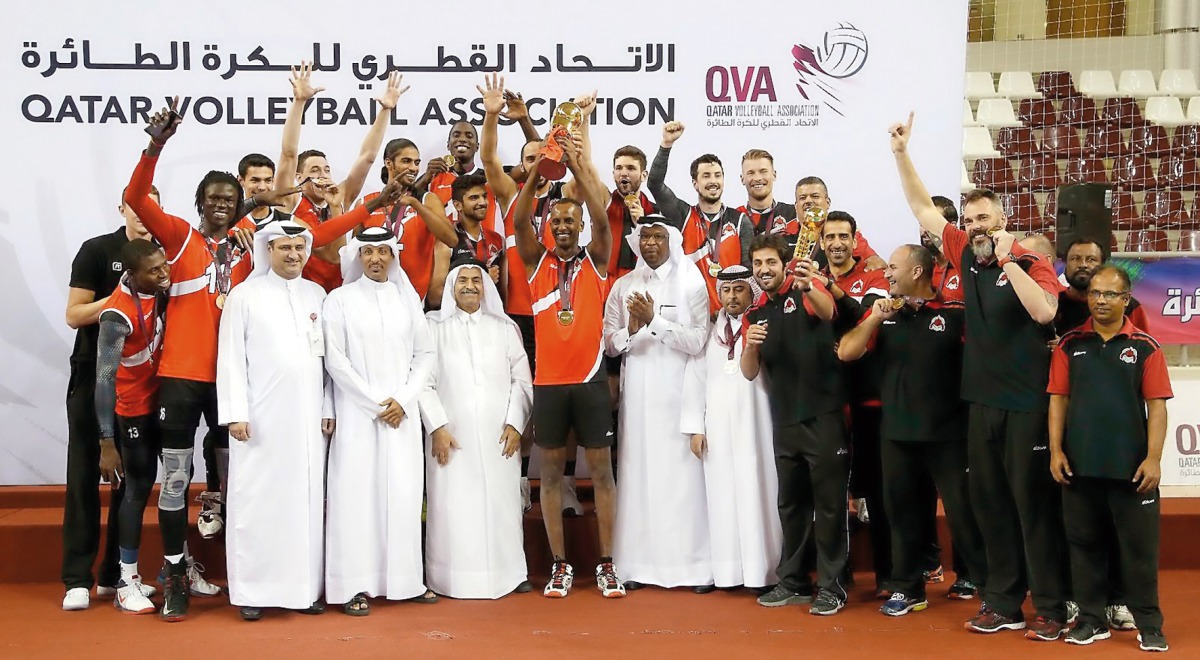Al Rayyan players and officials celebrate their win over Al Arabi in the final match of the Emir Cup volleyball at Qatar's Women's Sports Committee Hall during the presentation ceremony at Aspire Dome yesterday. 