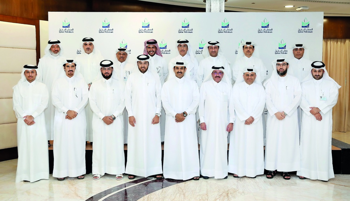 Qatar Petroleum (QP) employees pose for a group photo at the event.