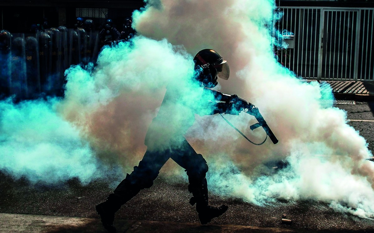 A member of the National Guard cracks down on opposition demonstrators during a march against President Nicolas Maduro, in Caracas
