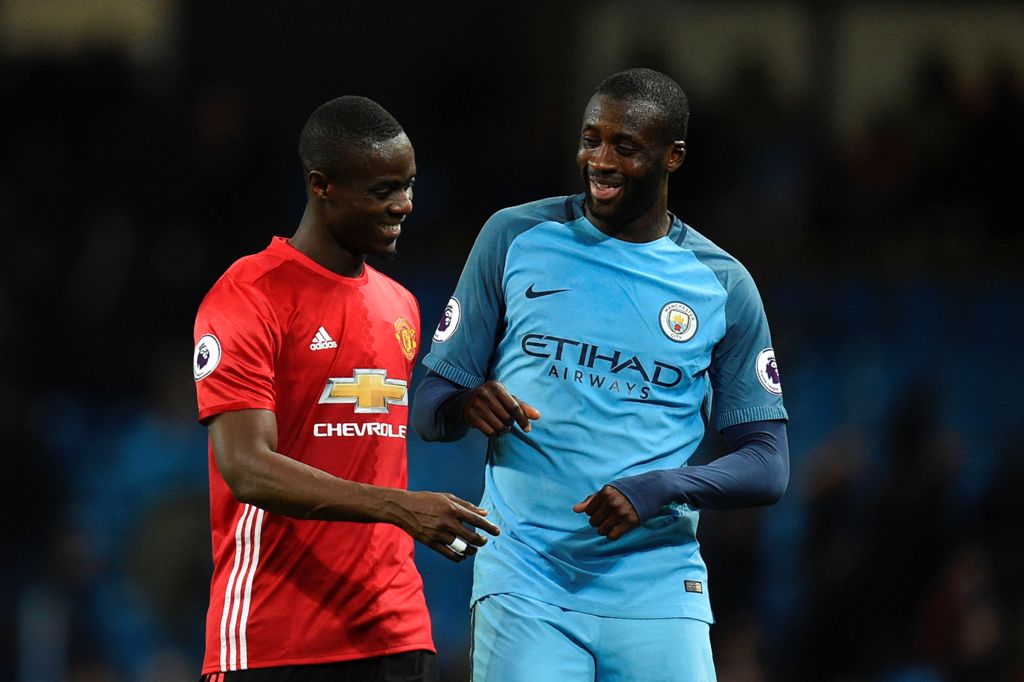 Manchester United's Ivorian defender Eric Bailly (L) talks with Manchester City's Ivorian midfielder Yaya Toure (R) at the end of the English Premier League football match between Manchester City and Manchester United at the Etihad Stadium in Manchester, 