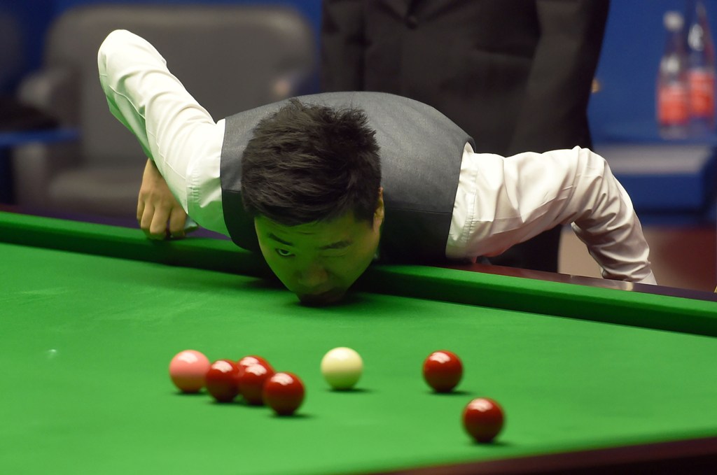 China's Ding Junhui contemplates a shot during the World Championship Snooker semi-final match against England's Mark Selby at The Crucible in Sheffield, England on April 28, 2017. / AFP / PAUL ELLIS
