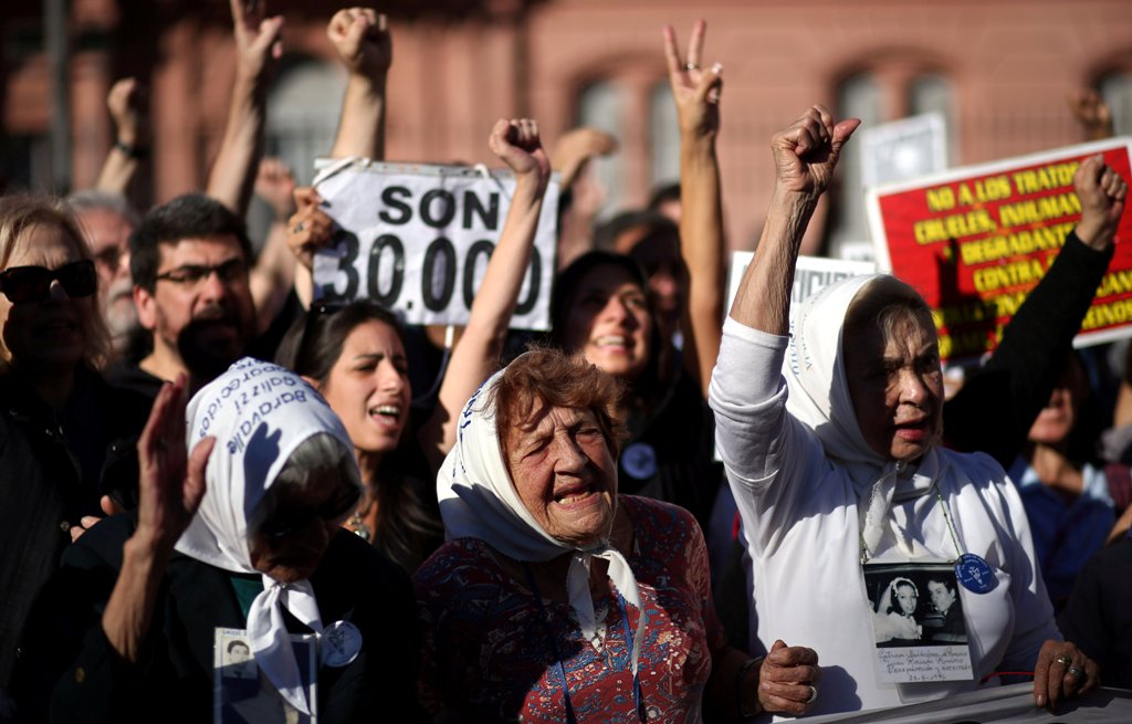 Members of the human rights group Madres de Plaza de Mayo (Mothers of the Disappeared) shout slogans during commemorations of the 40th anniversary of their first march to demand justice for their children, who went missing during Argentina's 1976-1983 mil