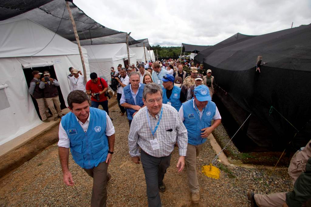 This handout picture released by the UN press office show Uruguay's ambassador at the UN Elbio Rosselli (C) and members of the United Nations Security Council upon arrival at the Transitional Standardization Zone in La Reforma municipality, Meta departmen