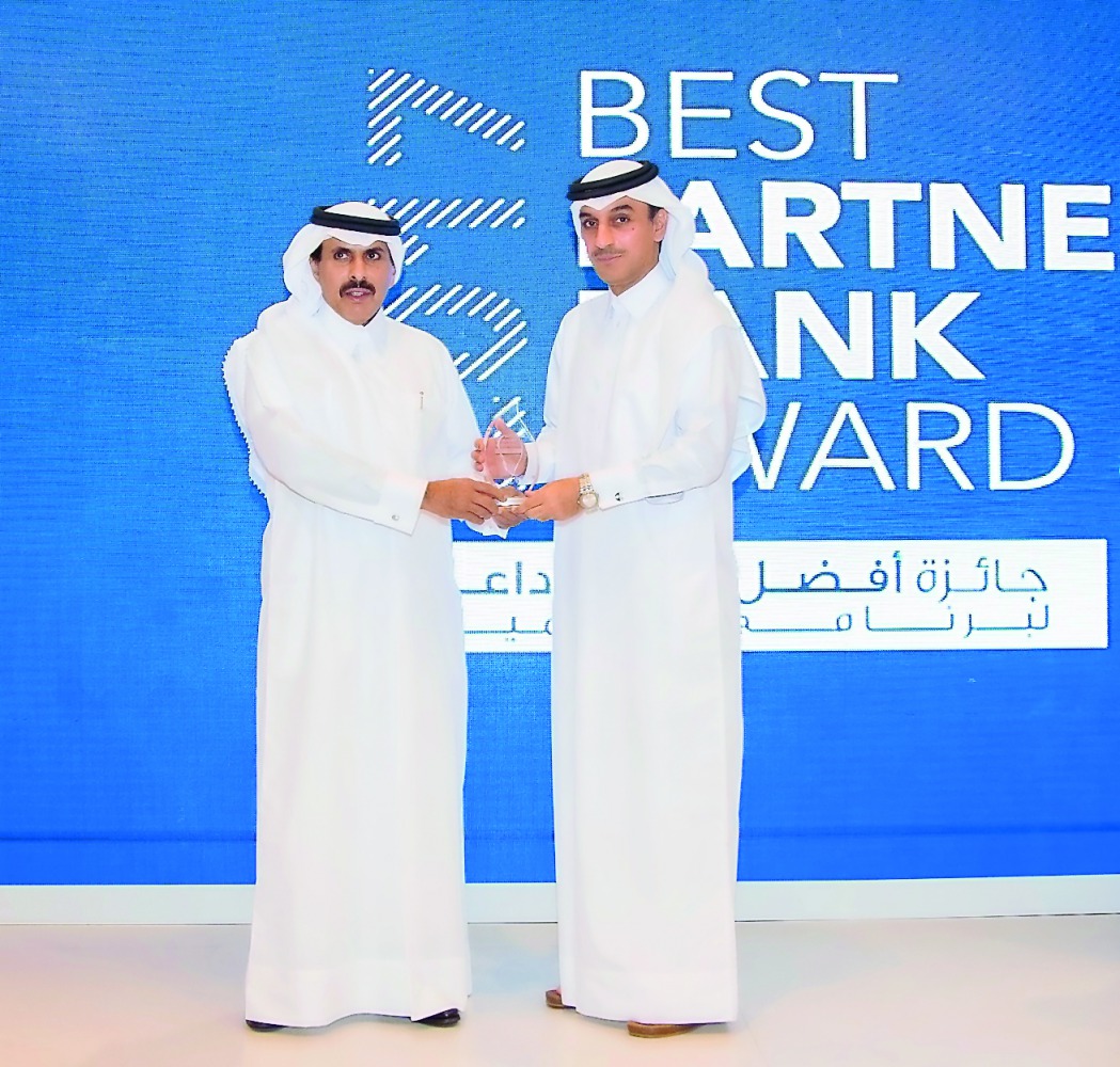 QIIB Deputy CEO Jamal Abdullah Al Jamal, (right) receiving the award from  Qatar Central Bank Governor H E  Sheikh Abdullah bin Saud Al Thani.